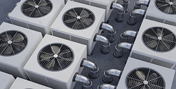 Row of commercial HVAC condenser units representing replacement, upgrade, and optimization solutions